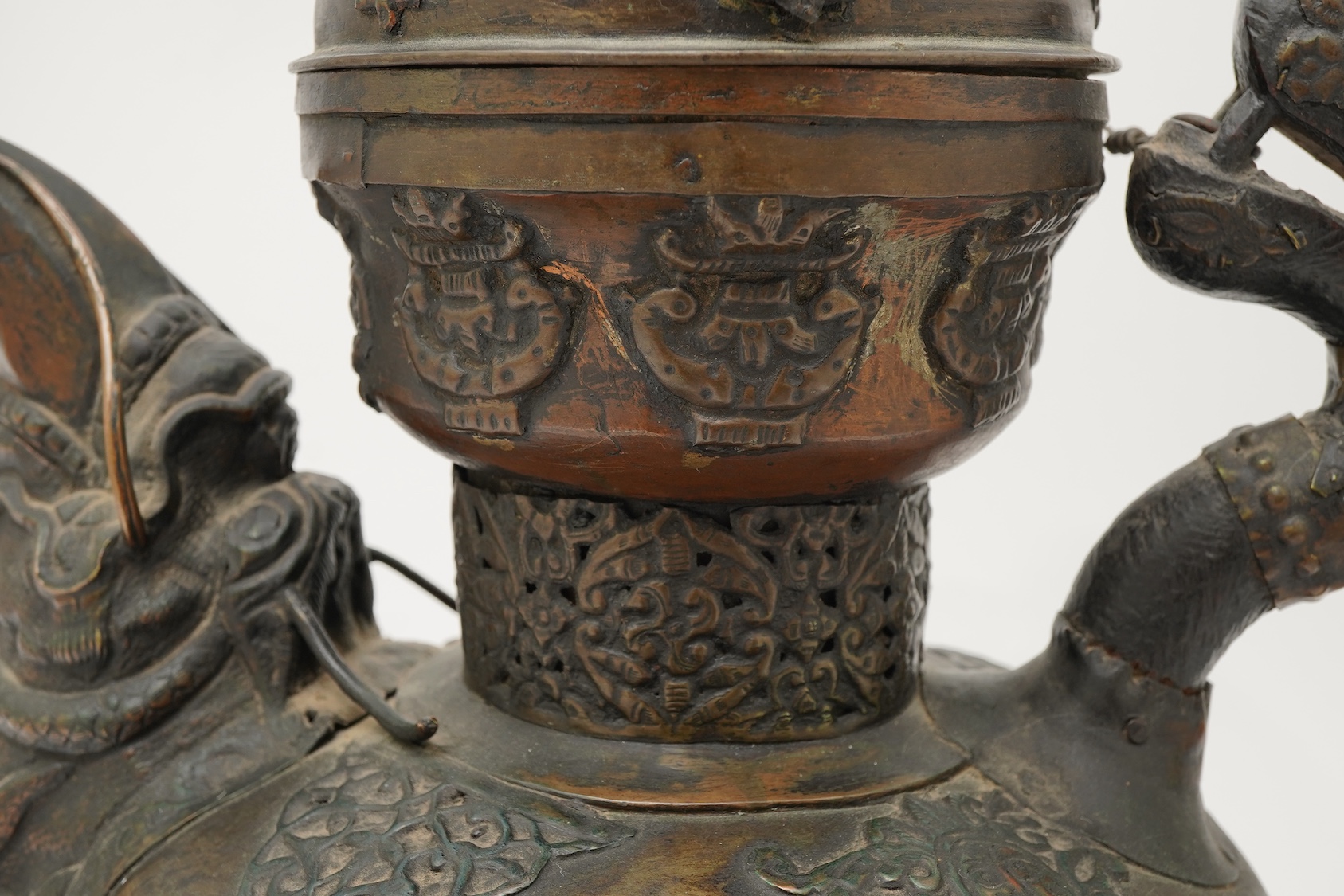 A large Tibetan repoussé brass and copper ewer, 19th century